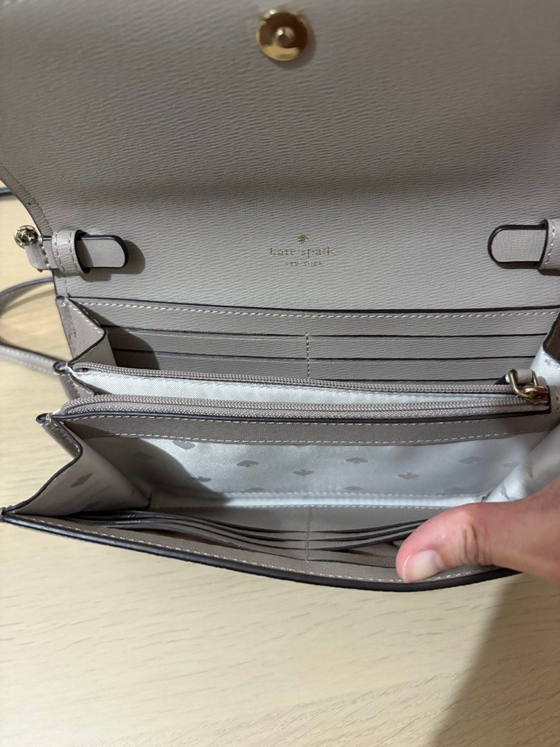 Kate Spade clutch bag (Category: Luxury Bags & Wallets) located in Manila. Submitted by isabellehm (Listing ID 1416243450, Image 2). Description: - Kate Spade wallet - Chain strap - Flap closure - Multiple card slots - Zippered compartment - Kate Spade New York logo - Solid, neutral color.