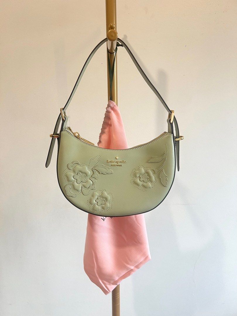 Kate Spade Crescent Shoulder (Category: Luxury Bags & Wallets) located in Makati City. Submitted by audreyngoldilocks (Listing ID 1416405939, Image 1). Description: - Kate Spade crescent-shaped handbag - Light green exterior - Gold-tone hardware - Includes matching pink dust bag - Adjustable strap - Zipper closure.