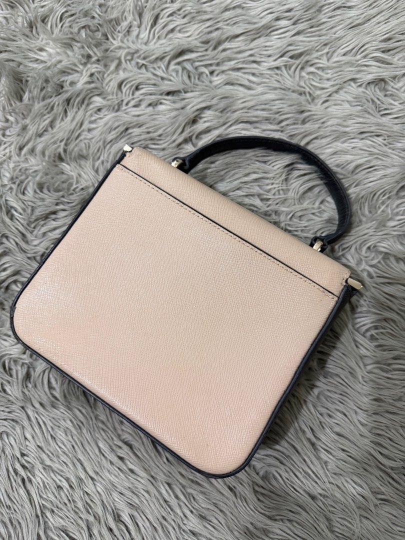 Kate Spade New York Handbag (Category: Luxury Bags & Wallets) located in Cabanatuan. Submitted by bianca00 (Listing ID 1416333568, Image 3). Description: - Kate Spade handbag - Dual-tone design: beige top, white bottom - Top handle - Magnetic closure - Beige interior - Black trim - Kate Spade New York logo on front.