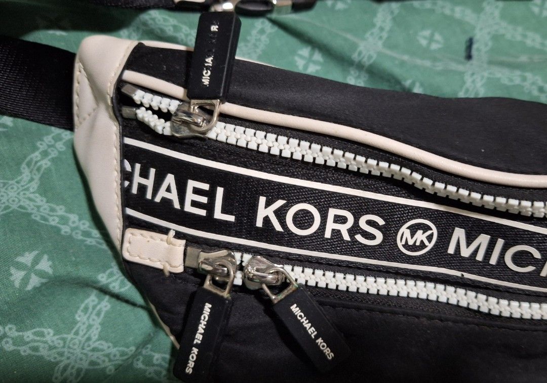 Michael Kors Kenly Medium Nylon Belt Bag (Category: Luxury Bags & Wallets) located in Manila. Submitted by natehiggers1 (Listing ID 1416345318, Image 3). Description: - Authentic Michael Kors fanny pack - Black with white accents - Adjustable black strap with silver buckle - Two zippered compartments - Black interior with Michael Kors logo - Includes care card and tag - Water and stain-resistant material Meetup in any Lrt/mrt stations shipping vi