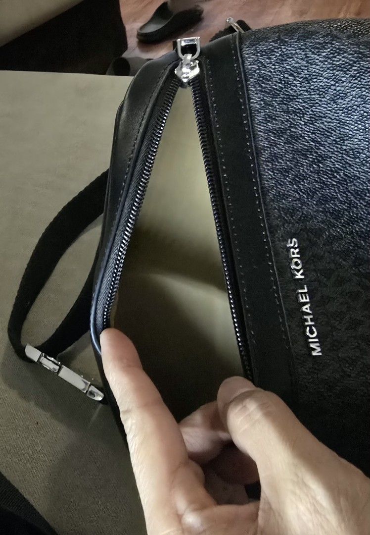 Michael Kors Waist Bag (Category: Luxury Bags & Wallets) located in Quezon City. Submitted by b.caster (Listing ID 1416300560, Image 3). Description: - Black Michael Kors waist bag - Zip closure - Adjustable strap - Features the Michael Kors logo pattern - Light beige interior - Metal buckle on strap.