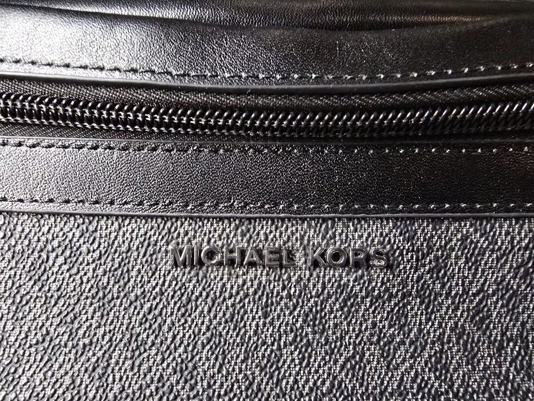 Michael Kors Waist Bag (Category: Luxury Bags & Wallets) located in Quezon City. Submitted by b.caster (Listing ID 1416300560, Image 2). Description: - Black Michael Kors waist bag - Zip closure - Adjustable strap - Features the Michael Kors logo pattern - Light beige interior - Metal buckle on strap.