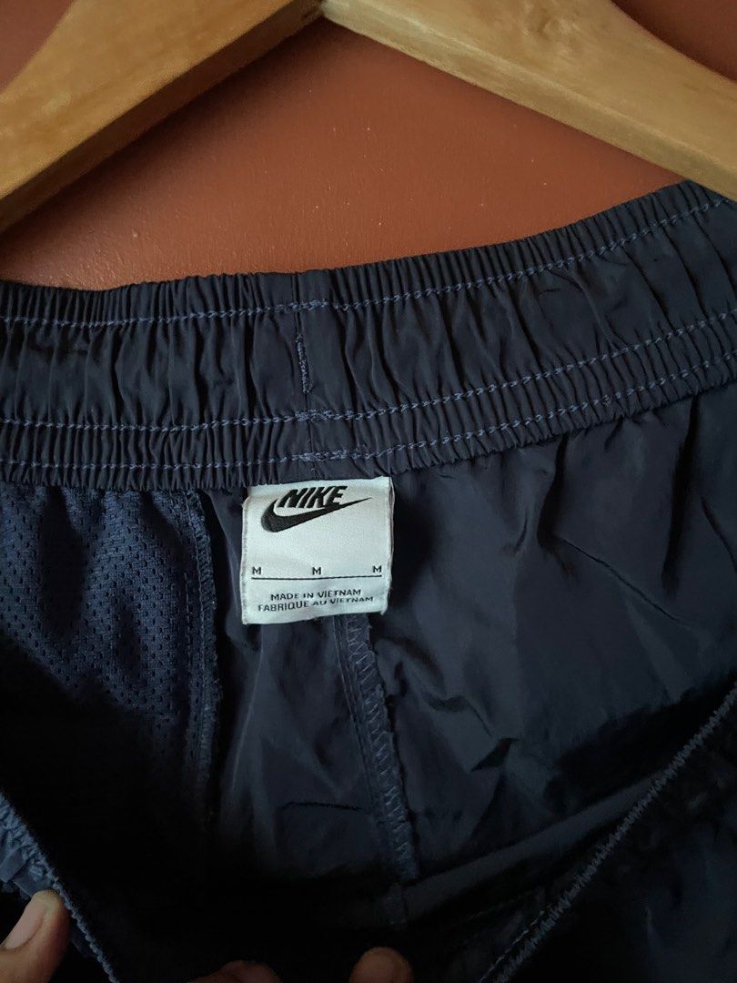 Nike Shorts with White Stripes - Size M (Category: Shorts) located in Manila. Submitted by threadsvault__ (Listing ID 1416302983, Image 2). Description: - Navy blue Nike shorts - White stripes on sides - Elastic waistband with drawstring - Size M - Made in Vietnam - Nike logo tag - Perfect for casual wear or workouts.