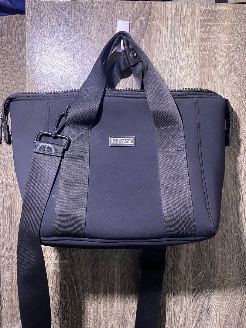 NuPrene Black Handbag with Shoulder Strap (Category: Shoulder Bags) located in Bacolod City. Submitted by lnnlryn (Listing ID 1416358058, Image 2). Description: - Black NuPrene handbag - Top handle and detachable shoulder strap - Zippered main compartment - Small brand logo - Rectangular shape - Neoprene-like material - Simple and functional design - SF c/o buyer.