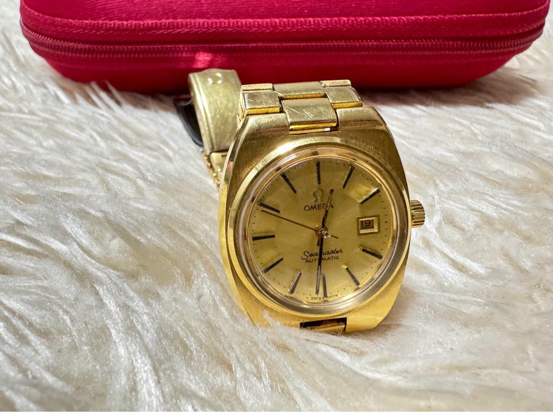 Omega Seamaster Automatic Gold Watch (Category: Luxury Watches) located in Pasig City. Submitted by pepay_c (Listing ID 1416398665, Image 3). Description: - Vintage Omega Seamaster automatic watch - Gold-toned dial with date display - Gold-toned bracelet - Includes red Omega case - Omega logo on dial and case - Swiss made.