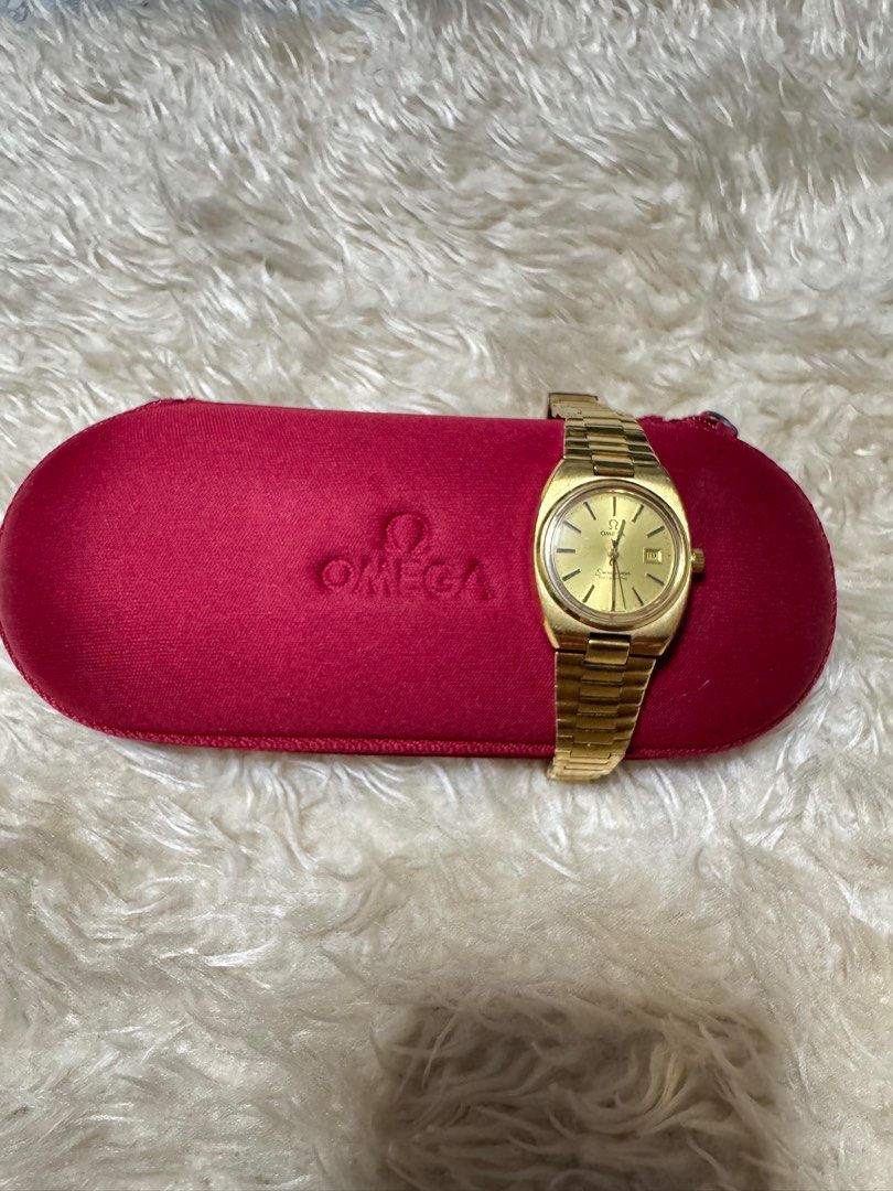 Omega Seamaster Automatic Gold Watch (Category: Luxury Watches) located in Pasig City. Submitted by pepay_c (Listing ID 1416398665, Image 1). Description: - Vintage Omega Seamaster automatic watch - Gold-toned dial with date display - Gold-toned bracelet - Includes red Omega case - Omega logo on dial and case - Swiss made.