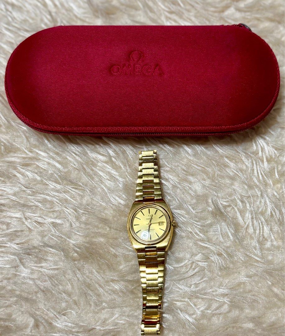Omega Seamaster Automatic Gold Watch (Category: Luxury Watches) located in Pasig City. Submitted by pepay_c (Listing ID 1416398665, Image 2). Description: - Vintage Omega Seamaster automatic watch - Gold-toned dial with date display - Gold-toned bracelet - Includes red Omega case - Omega logo on dial and case - Swiss made.