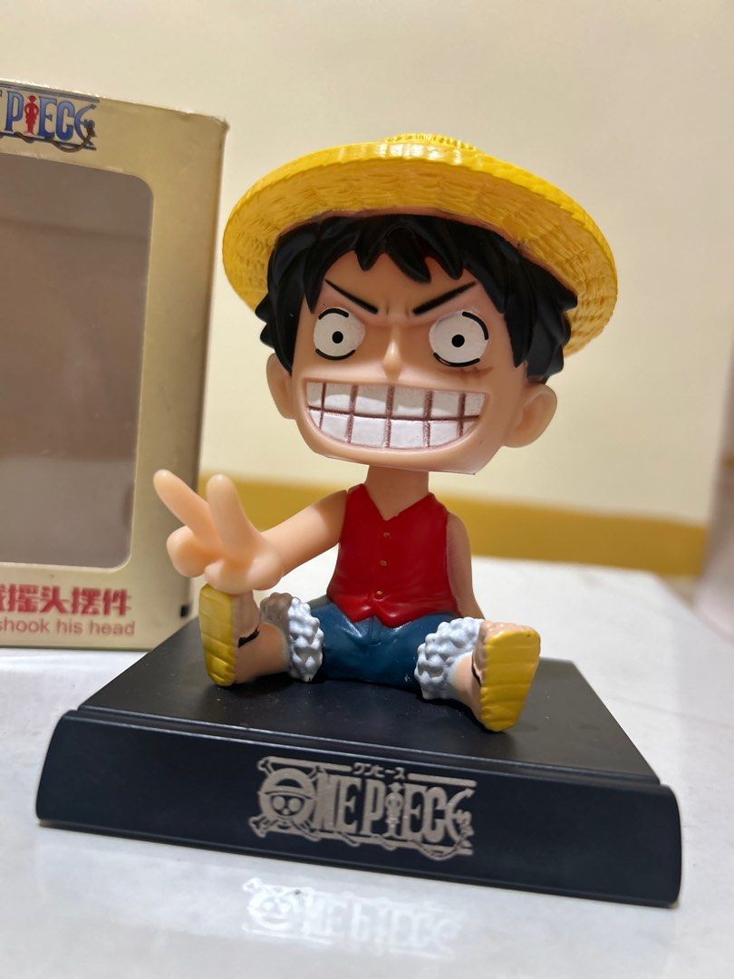 One Piece Luffy Bobblehead Figurine Anime (Category: Figurines & Statues) located in Valenzuela. Submitted by dessifinds (Listing ID 1416280567, Image 3). Description: One Piece Luffy bobblehead figurine. Features Luffy in his iconic outfit with a straw hat. The figurine is on a black base with the One Piece logo. Comes with its original box. The head is spring-mounted, allowing it to bobble. Perfect for One Piece fans and collectors..