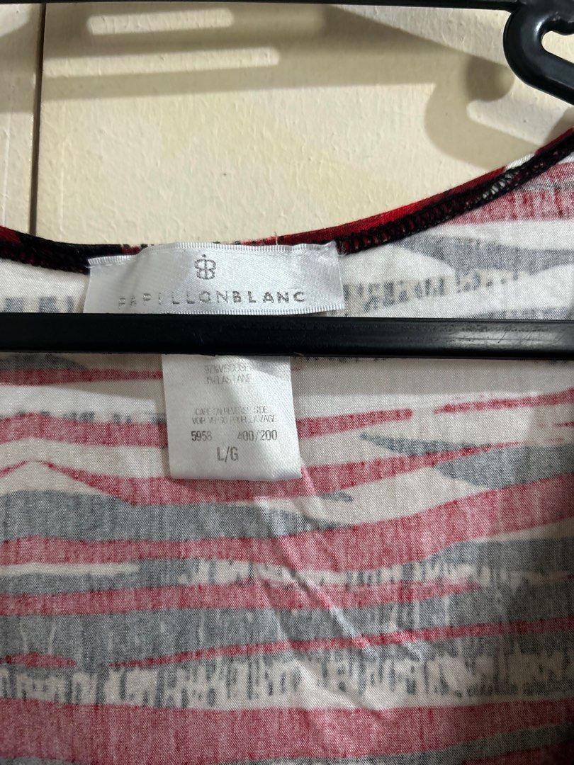 Papillon Blanc Sleeveless Top - L/G (Category: Sleeveless) located in Taguig. Submitted by pinkpixie.444 (Listing ID 1416235843, Image 2). Description: - Papillon Blanc sleeveless top - Fits S-M - Design: Cowl neck with red, black, and white stripes - Fabric: Soft and breathable - Ideal for casual wear.