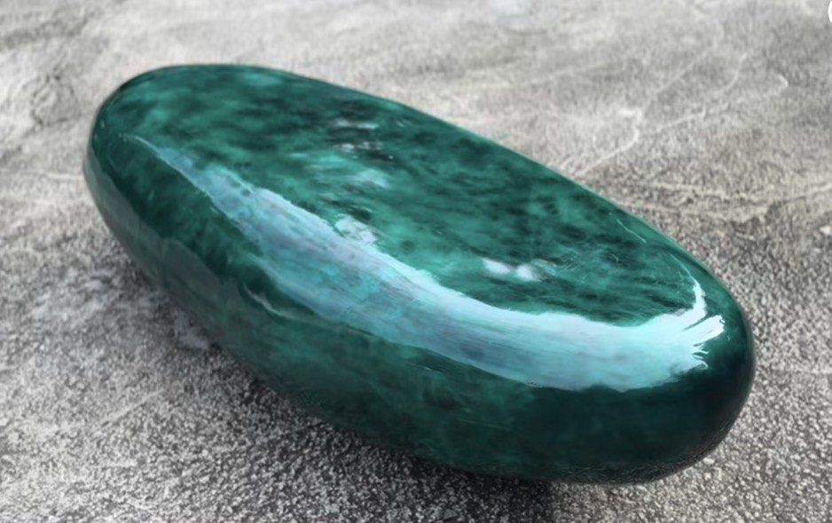 Pebble shaped in and outdoor bench/coffee table. (Category: Other Home Furniture) located in Makati City. Submitted by olxph_299450477 (Listing ID 1416350979, Image 3). Description: Good day, This green pebble shaped stone measures Length-180cm x Width-80 x Height 47cm. This can be used as a bench or a center table. It is made of 6 layers of epoxy which are individually painted with transparent green shades and black to create an artistic represe