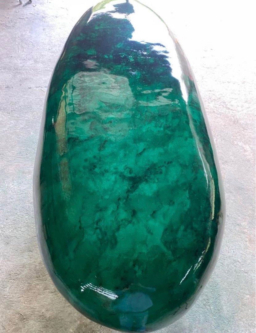 Pebble shaped in and outdoor bench/coffee table. (Category: Other Home Furniture) located in Makati City. Submitted by olxph_299450477 (Listing ID 1416350979, Image 1). Description: Good day, This green pebble shaped stone measures Length-180cm x Width-80 x Height 47cm. This can be used as a bench or a center table. It is made of 6 layers of epoxy which are individually painted with transparent green shades and black to create an artistic represe