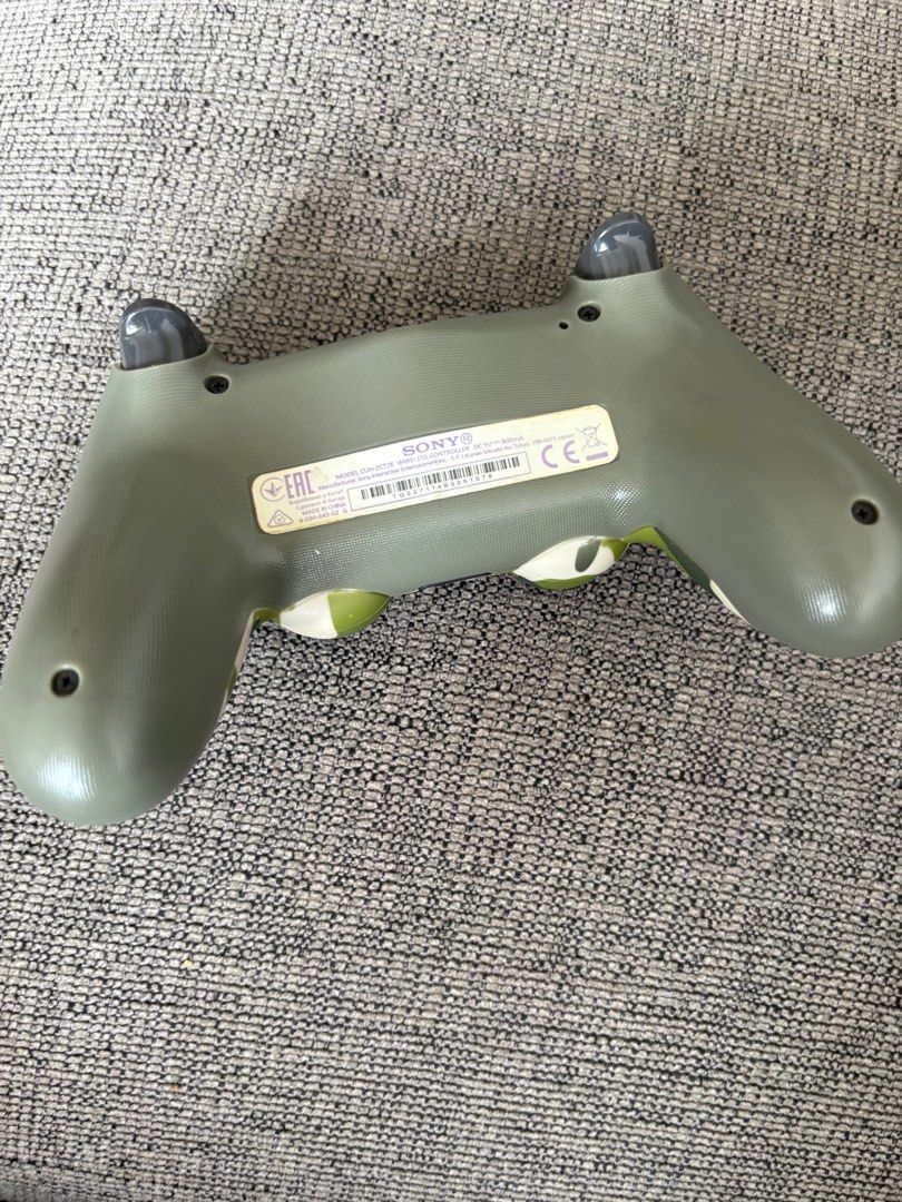 PS4 controller (Category: Controllers) located in Singapore. Submitted by 28dxf6sycf74537 (Listing ID 1416281216, Image 2). Description: - Used Sony PlayStation 4 controller - Camouflage design - Buttons and joysticks show wear - Tested and fully functional - Perfect for gaming! Authentic controller selling at very cheap.