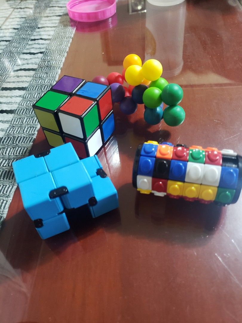 Puzzle Cube, Infinity Cube, and Magnetic Balls (Category: Board Games & Puzzles) located in Manila. Submitted by feg39 (Listing ID 1416255512, Image 2). Description: - Puzzle Cube: Multi-colored sides for a classic challenge. - Infinity Cube: Smooth blue design for endless fidgeting. - Magnetic Balls: Various colors for creative play and stress relief. - Great for: Stress relief and fun!.