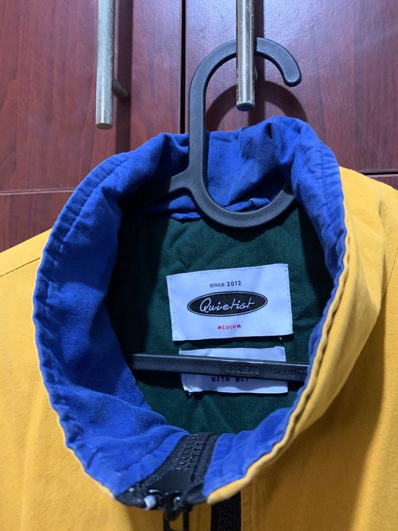 Quietist Plasticate Jacket - Medium (Category: Coats, Jackets and Outerwear) located in Makati City. Submitted by heremaya (Listing ID 1416366008, Image 3). Description: W: 21 L: 25 - Brand: Quietist - Color: Yellow with black accents - Size: Medium - Features: - Blue and green collar lining - Full zipper closure - Drawstring hem - Design: 'Plasticate' printed on the front Shipping fee will be shouldered by buyer. Metro Manila area..