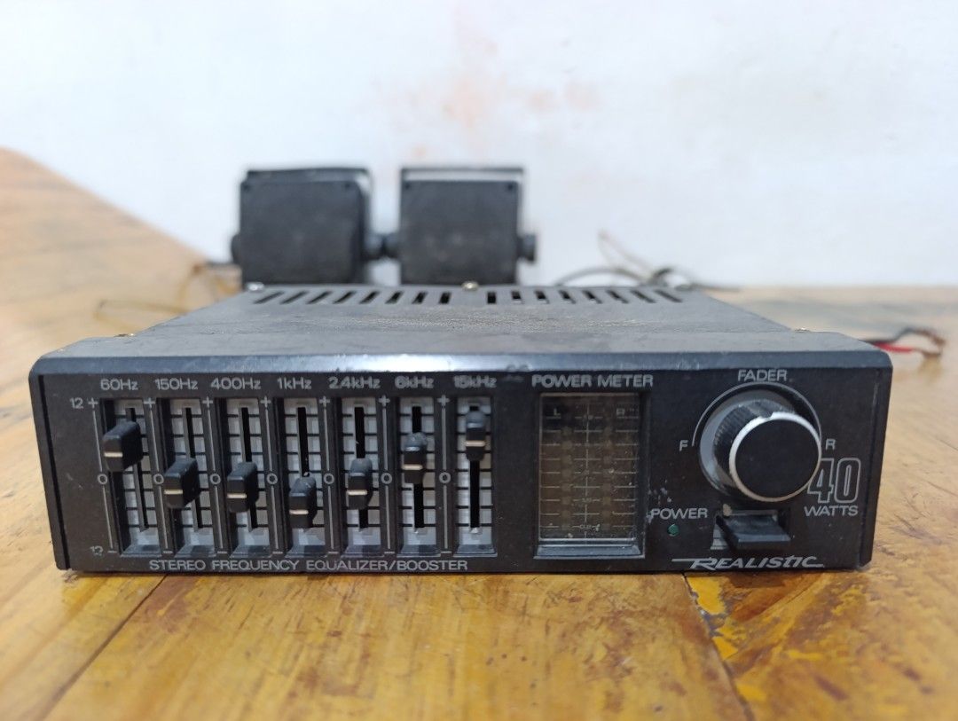 Realistic Equalizer/Booster 40 Watts (Category: Soundbars, Speakers & Amplifiers) located in Quezon City. Submitted by yourstruly2018 (Listing ID 1416276740, Image 1). Description: - Realistic stereo frequency equalizer/booster - Features a power meter and fader control - Multiple frequency adjustment sliders - Power switch included - Sleek black exterior with ventilation slots - Various input/output connectors - 40 Watts power output.