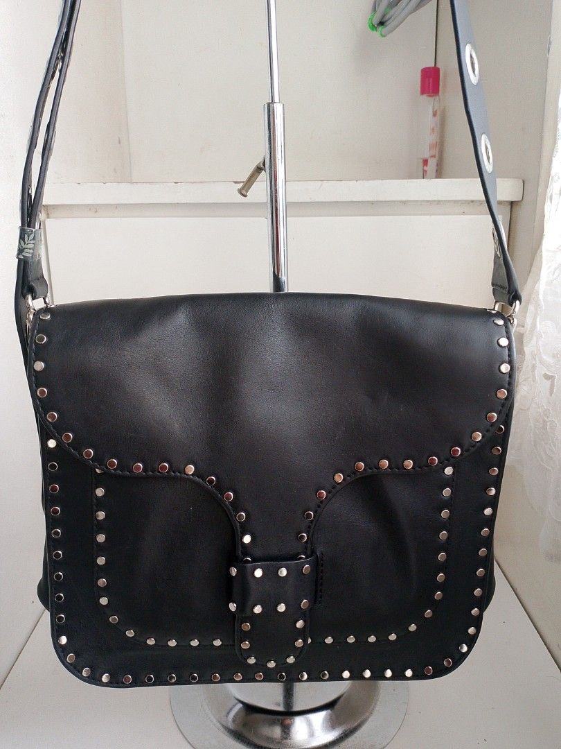 Rebecca Minkoff Studded Shoulder Bag (Category: Luxury Bags & Wallets) located in Quezon City. Submitted by chicportfolioboutique (Listing ID 1416232479, Image 1). Description: - Rebecca Minkoff shoulder bag - Black leather - Silver-tone stud detailing - Adjustable shoulder strap - Flap closure - Interior: Main compartment and slip pocket - Brand name visible inside.