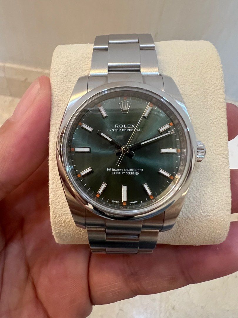 Rolex Oyster Perpetual Green Dial (34mm) (Category: Watches) located in Singapore. Submitted by flstf1340 (Listing ID 1416344953, Image 1). Description: - Rolex Oyster Perpetual 114200 green dial - Includes original box, papers (dated May 2017), and tags - A timeless collector's item - Rare local let ( Singapore AD).