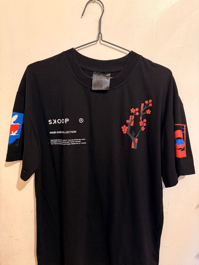 Skoop Wabi-Sabi Collection Graphic Tee Large (Category: Tshirts & Polo Shirts ) located in Imus. Submitted by ilexncle (Listing ID 1416264246, Image 1). Description: - Black Skoop Wabi-Sabi Collection graphic tee - Features a cherry blossom design on the front - "Own It" text on the back - Includes graphics on the sleeves Condition: 9/10. Cracks on some prints at the back due to usage and laundry. Lightly used. Tag washed out due to laundry..