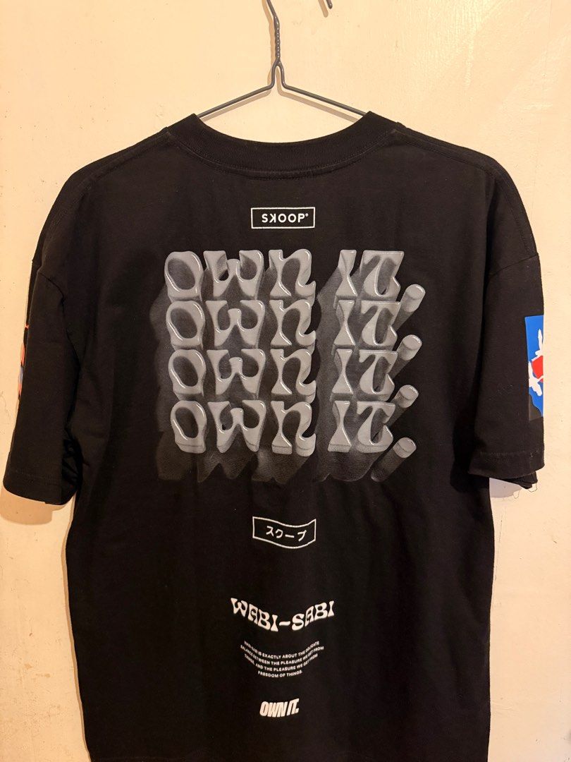 Skoop Wabi-Sabi Collection Graphic Tee Large (Category: Tshirts & Polo Shirts ) located in Imus. Submitted by ilexncle (Listing ID 1416264246, Image 2). Description: - Black Skoop Wabi-Sabi Collection graphic tee - Features a cherry blossom design on the front - "Own It" text on the back - Includes graphics on the sleeves Condition: 9/10. Cracks on some prints at the back due to usage and laundry. Lightly used. Tag washed out due to laundry..
