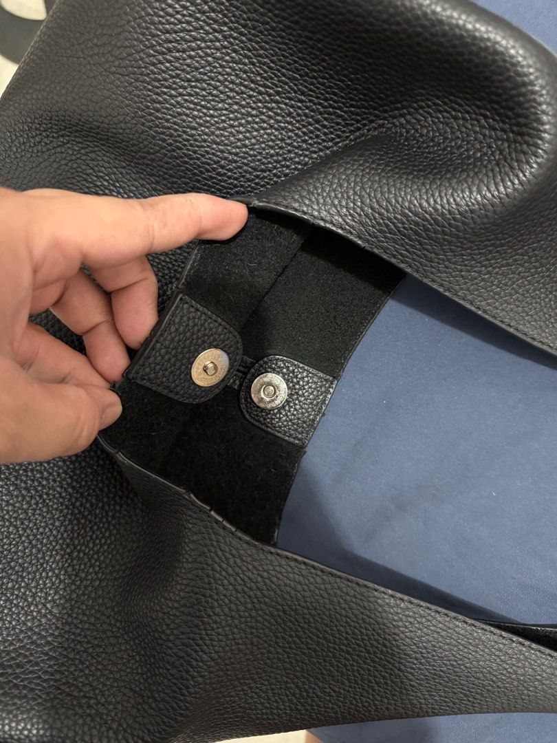 Sobien Leather Hobo Bag (Category: Shoulder Bags) located in Quezon City. Submitted by ramearc (Listing ID 1416361457, Image 3). Description: - Black hobo bag - Single shoulder strap - Magnetic snap closure - Suede interior - Pebble genuine leather - Only issue is cracked piping - Can fit Ipad 11th Gen A6 RFS: Decluttering.