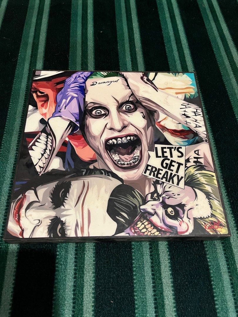Suicide Squad Joker Frame (Category: Everything Else Others) located in Las Pinas. Submitted by tickya (Listing ID 1416285938, Image 1). Description: - Suicide Squad Frame featuring The Joker. - Cover art: Collage of Joker images. - Includes the phrase "Let's Get Freaky". - 10x10 inches.