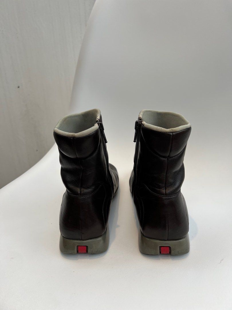 Vintage 90s Prada Leather Boots (Category: Boots) located in Binan City. Submitted by ninibuyshere (Listing ID 1416216416, Image 2). Description: RFS: Declutterring Price is negotiable Size 35 on tag but fits 36 - Vintage leather Prada boots - Square toe design - Side zippers - Padded collar - Gray sole with red accent - Prada logo visible inside - Soles show wear - Check photos to see minor flaws - No Box.