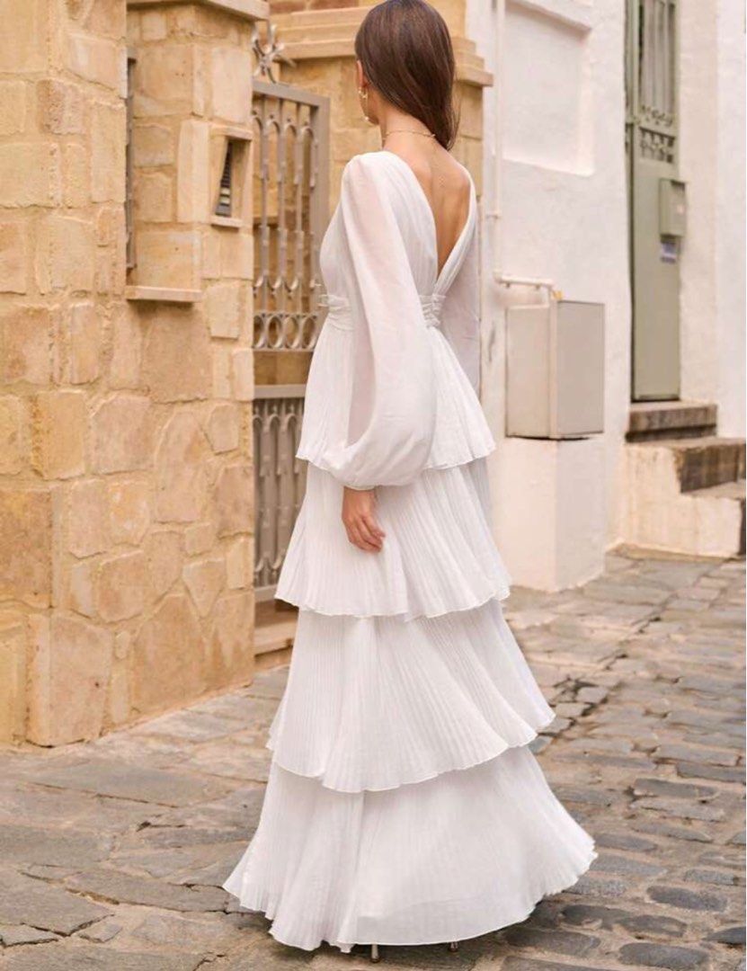 White Pleated Maxi Dress wedding dres (Category: Dresses) located in Quezon City. Submitted by raca_preloved (Listing ID 1416345870, Image 2). Description: Used once (prep shoot for the wedding) Wedding dress Prep dress Size: small on tag - White maxi dress - Plunging neckline (sewed it para di revealing) - Long sleeves - Pleated design with tiered layers - High front slit - Ideal for special occasions and formal events.