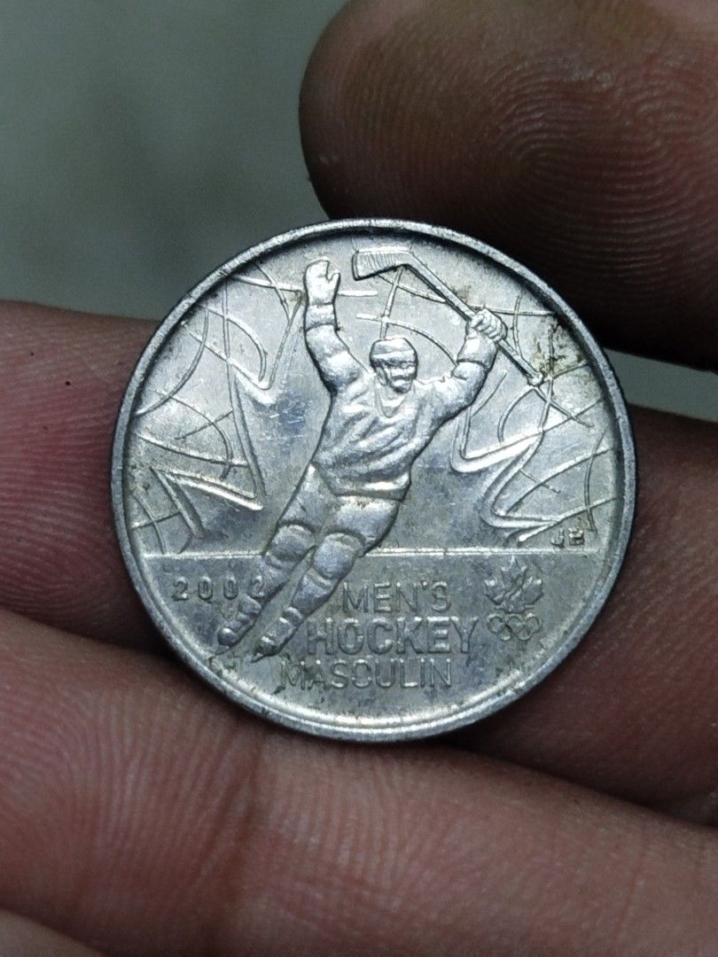 2009 Canada 25 Cents commemirative Coin (Category: Currency) located in Subic. Submitted by regiedaniel01 (Listing ID 1416580401, Image 2). Description: - 2009 Canadian 25-cent coin - Features Queen Elizabeth II (obverse) - Hockey player design (reverse) - Silver color - Collectible item.