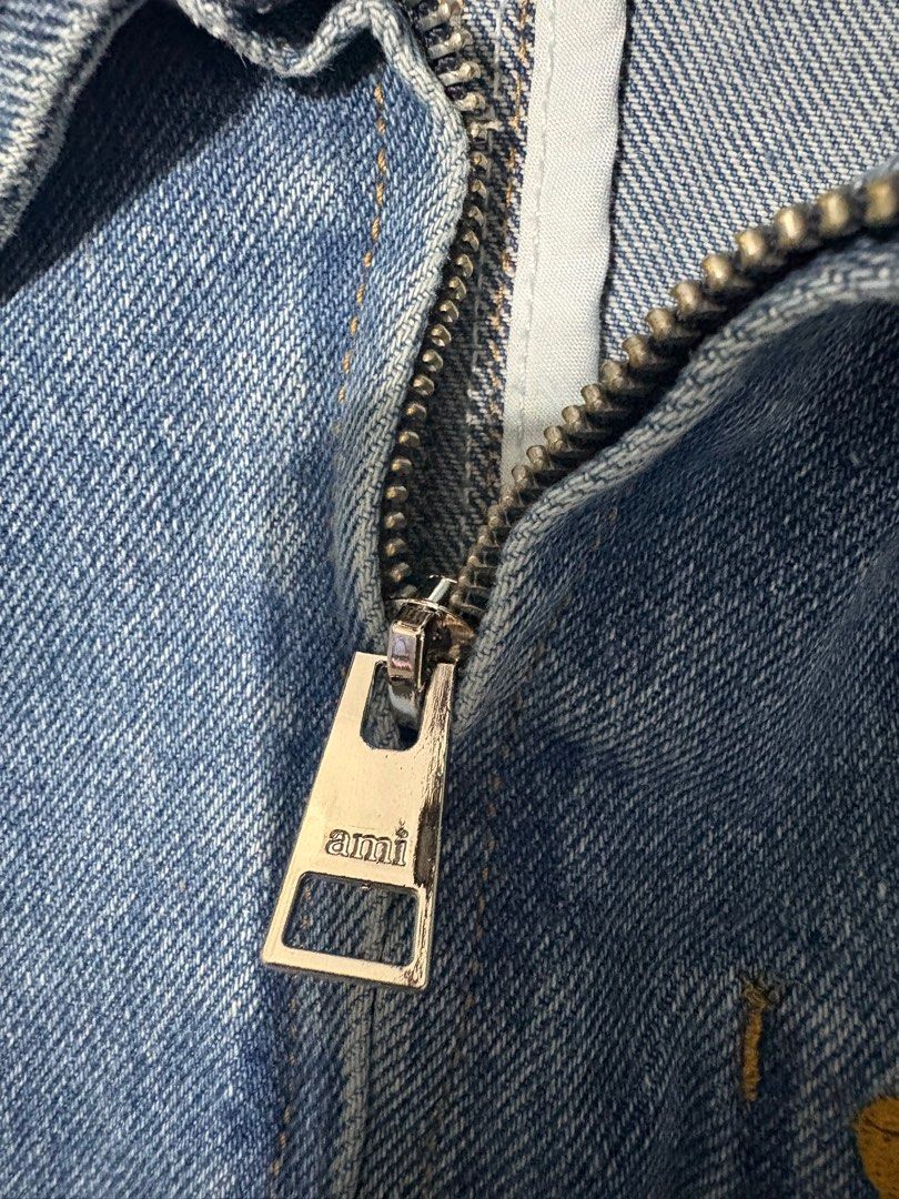 AMI Paris Denim Jacket (Category: Coats, Jackets and Outerwear) located in Antipolo. Submitted by gsauze (Listing ID 1416450234, Image 3). Description: - AMI Paris denim jacket - Size: L - Light blue wash - Classic design with zip closure - Features a small chest pocket - AMI logo on zipper and chest - Made in Portugal.