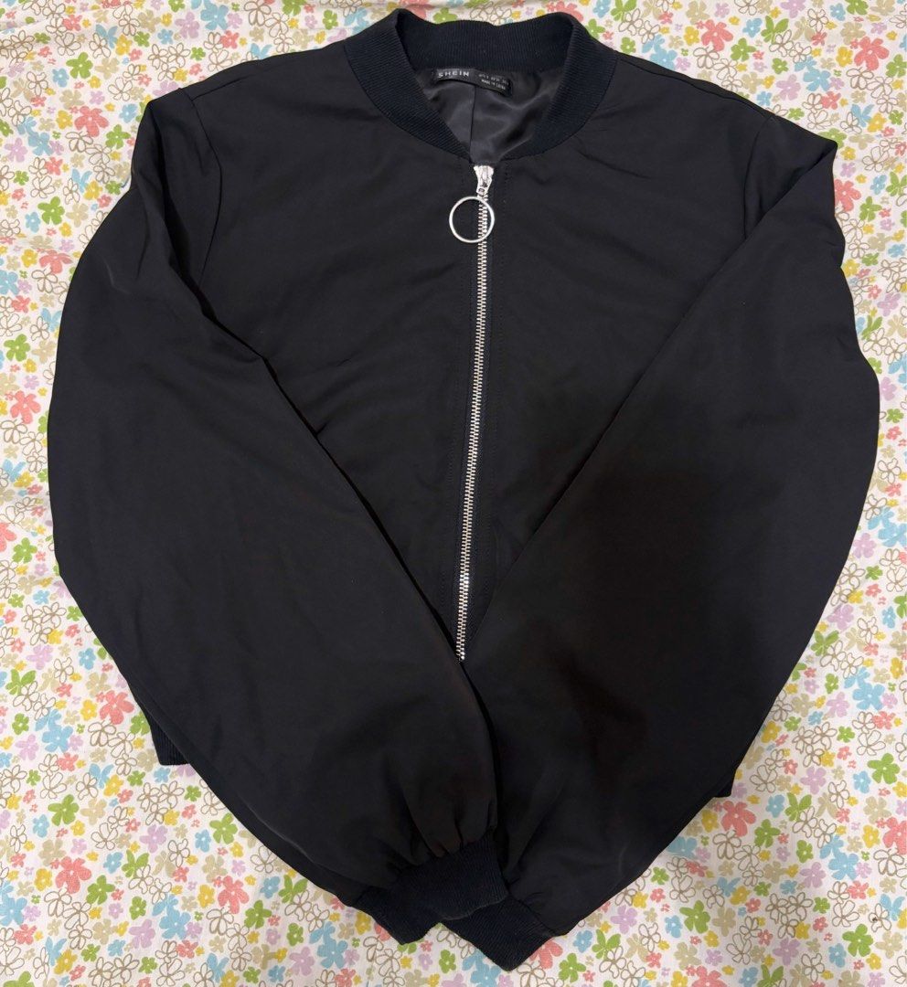 Black Bomber Jacket (Category: Coats, Jackets and Outerwear) located in Manila. Submitted by royalrabbit-943762 (Listing ID 1416534927, Image 1). Description: - Black bomber jacket - Silver zipper and ring detail - Ribbed collar and cuffs - Long sleeves - Lightweight, smooth fabric - Tagged.