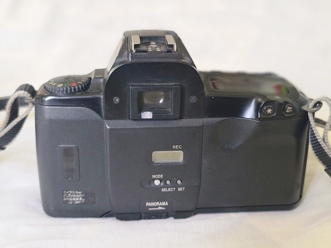 Canon EOS Kiss Camera (Category: Cameras) located in Manila. Submitted by gane_esla (Listing ID 1416502504, Image 2). Description: FOR COLLECTORS' USE ONLY. NOT WORKING - Canon EOS Kiss camera - Includes lens cap and strap - Features panorama mode - Black camera body - Viewfinder and control buttons.