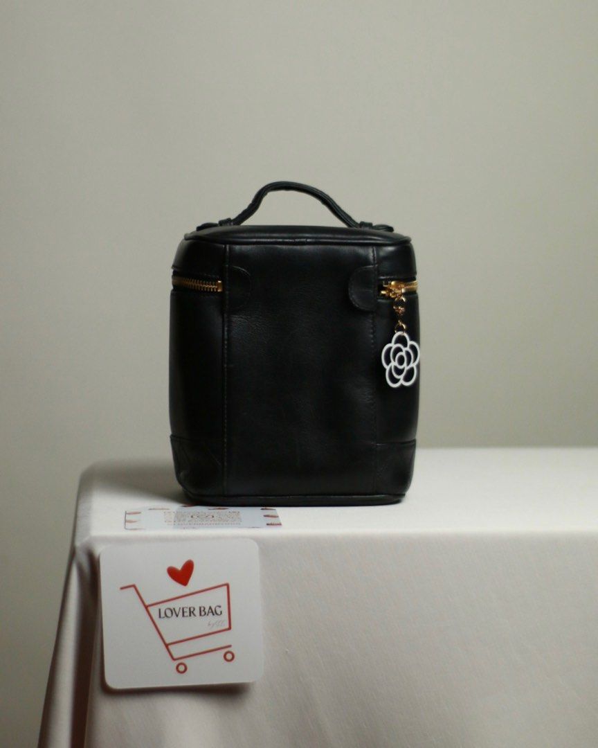 Chanel Vanity Bag Black (Category: Belt bags, Clutches and Pouches) located in Manila. Submitted by bagrx (Listing ID 1416617097, Image 3). Description: - Authentic Chanel vanity bag - Classic black color - Top handle design - Gold-tone zipper - Includes a charming flower detail - Features the iconic Chanel logo - Quilted bottom - Comes with a certificate of assessment with cert .