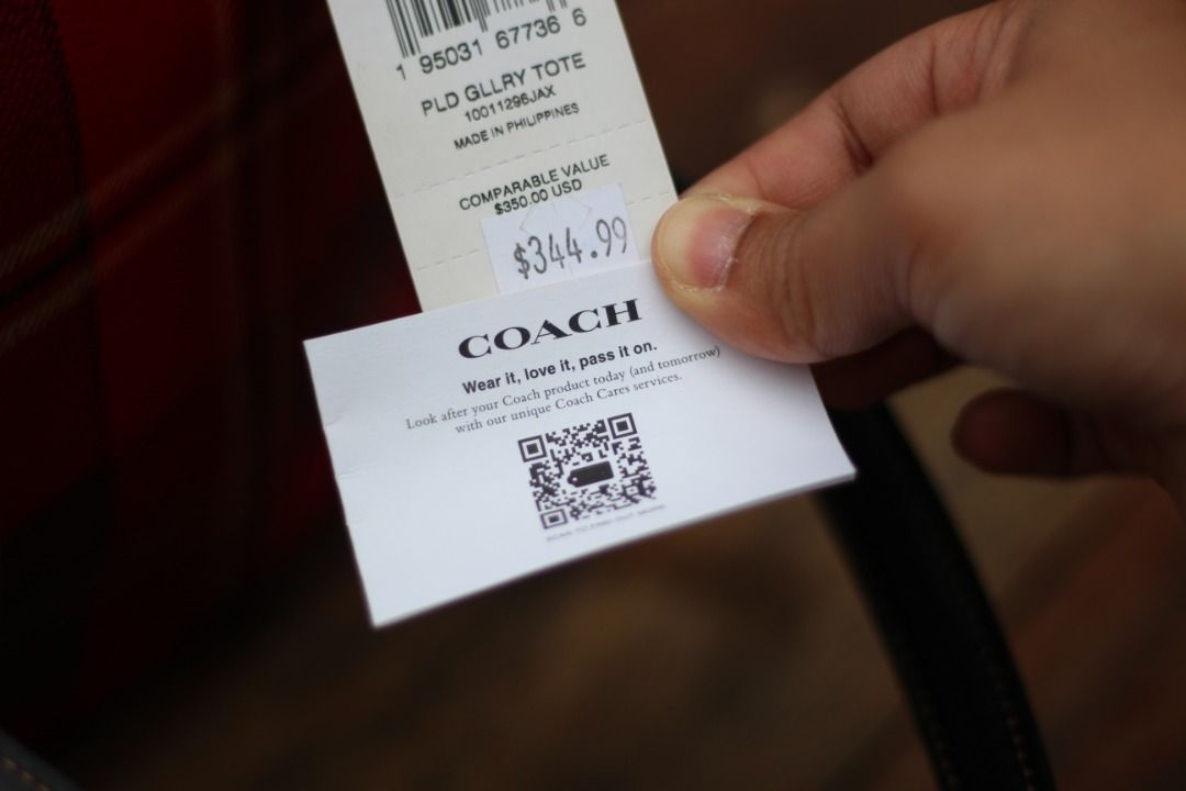 [AUTHENTIC] Coach Gallery Tote in Plaid print (Category: Luxury Bags & Wallets) located in Manila. Submitted by jjalbert (Listing ID 1416517011, Image 3). Description: Authentic Coach tote bag in a vibrant red plaid pattern. Features black leather handles and trim, a top zipper closure, and a Coach hang tag. The bag includes an interior zipper pocket. The original price tag is still attached, showing a comparable value of $350 USD. RFS: I dont li