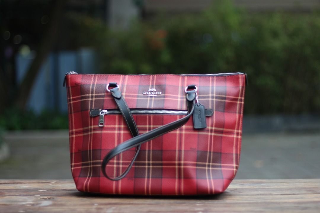 [AUTHENTIC] Coach Gallery Tote in Plaid print (Category: Luxury Bags & Wallets) located in Manila. Submitted by jjalbert (Listing ID 1416517011, Image 1). Description: Authentic Coach tote bag in a vibrant red plaid pattern. Features black leather handles and trim, a top zipper closure, and a Coach hang tag. The bag includes an interior zipper pocket. The original price tag is still attached, showing a comparable value of $350 USD. RFS: I dont li