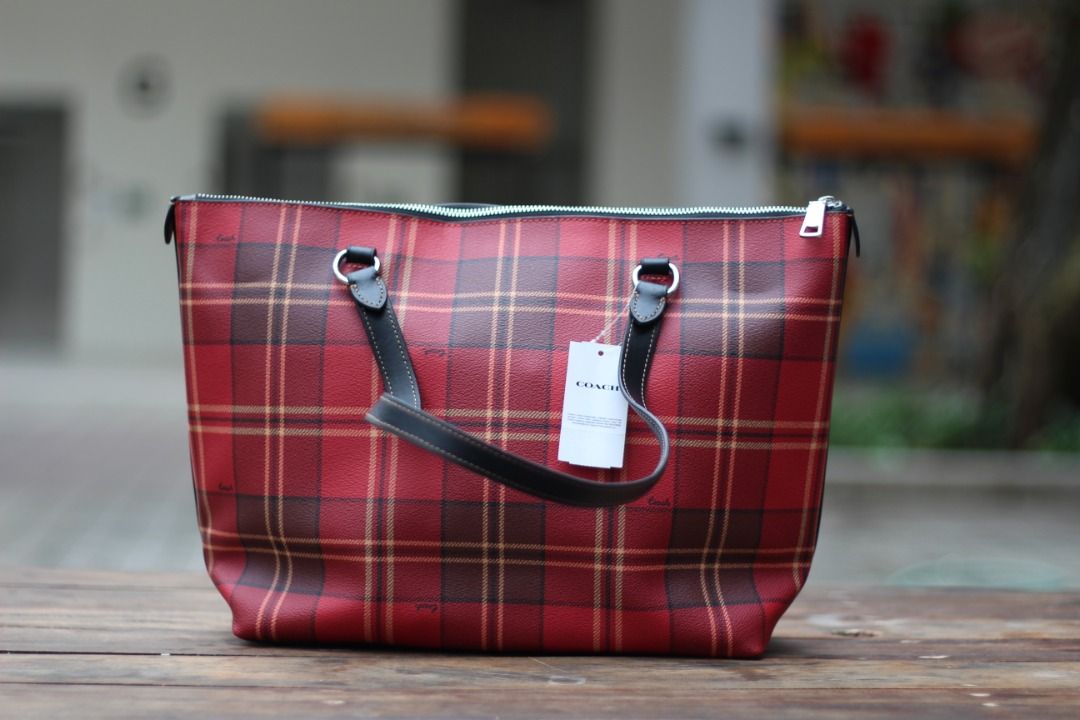 [AUTHENTIC] Coach Gallery Tote in Plaid print (Category: Luxury Bags & Wallets) located in Manila. Submitted by jjalbert (Listing ID 1416517011, Image 2). Description: Authentic Coach tote bag in a vibrant red plaid pattern. Features black leather handles and trim, a top zipper closure, and a Coach hang tag. The bag includes an interior zipper pocket. The original price tag is still attached, showing a comparable value of $350 USD. RFS: I dont li