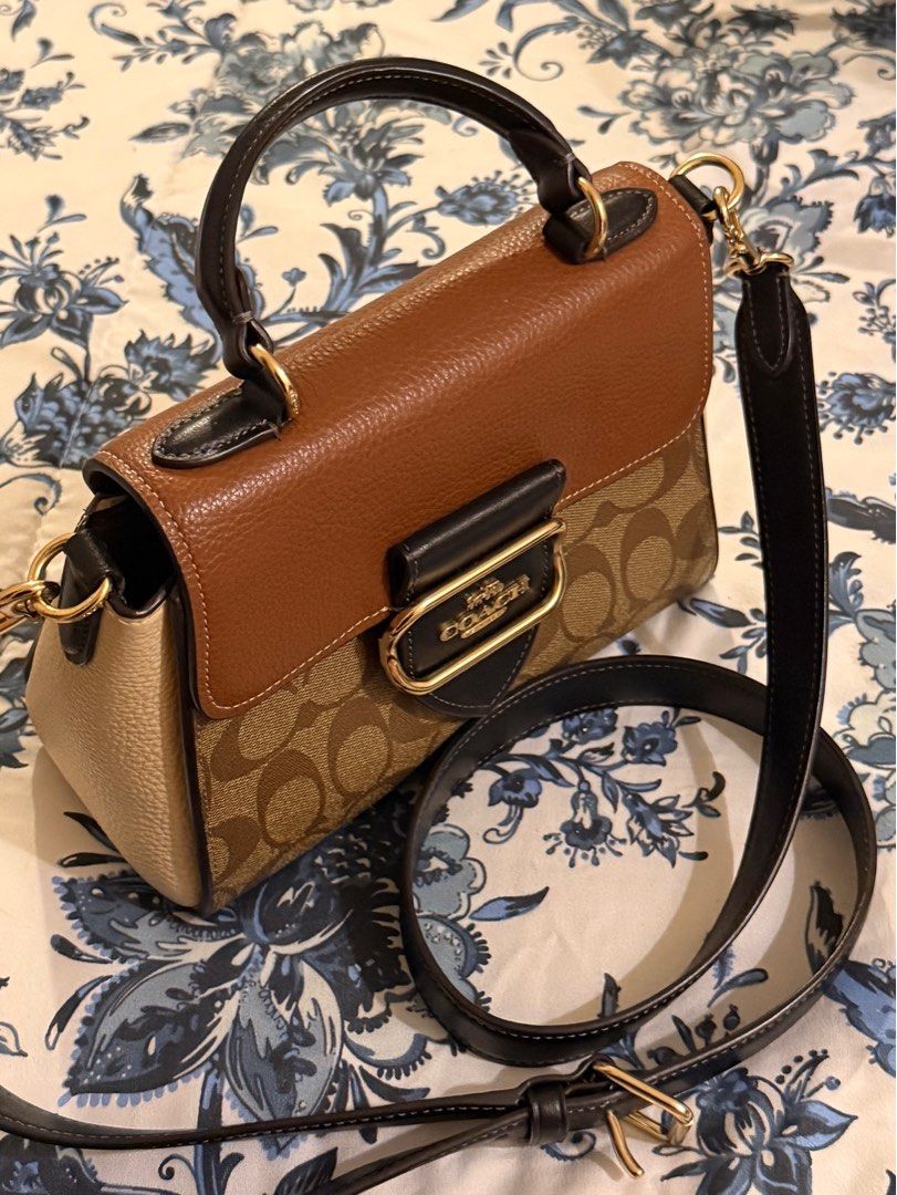Coach Morgan Top Handle Satchel (Category: Luxury Bags & Wallets) located in Manila. Submitted by rocco_ (Listing ID 1416611555, Image 2). Description: Coach handbag with signature pattern, top handle, and detachable strap. Features brown leather and gold-tone clasp. No issues, worn once or twice only. Dimensions: Length: 4.25" Height: 8.25" Width: 6.25".