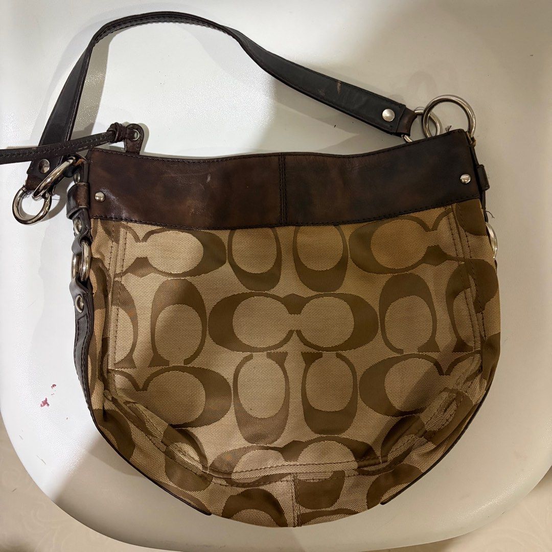 Coach Signature Hobo Bag (Category: Luxury Bags & Wallets) located in Quezon City. Submitted by rutobeans (Listing ID 1416470649, Image 2). Description: - Authentic Coach hobo bag - Signature Coach pattern - Brown leather trim and strap - Multiple interior compartments - Purple lining - Silver hardware - Zip closure - Includes Coach tag: C1069-F14706 J&T/Lalamove.