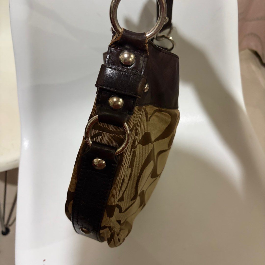 Coach Signature Hobo Bag (Category: Luxury Bags & Wallets) located in Quezon City. Submitted by rutobeans (Listing ID 1416470649, Image 3). Description: - Authentic Coach hobo bag - Signature Coach pattern - Brown leather trim and strap - Multiple interior compartments - Purple lining - Silver hardware - Zip closure - Includes Coach tag: C1069-F14706 J&T/Lalamove.