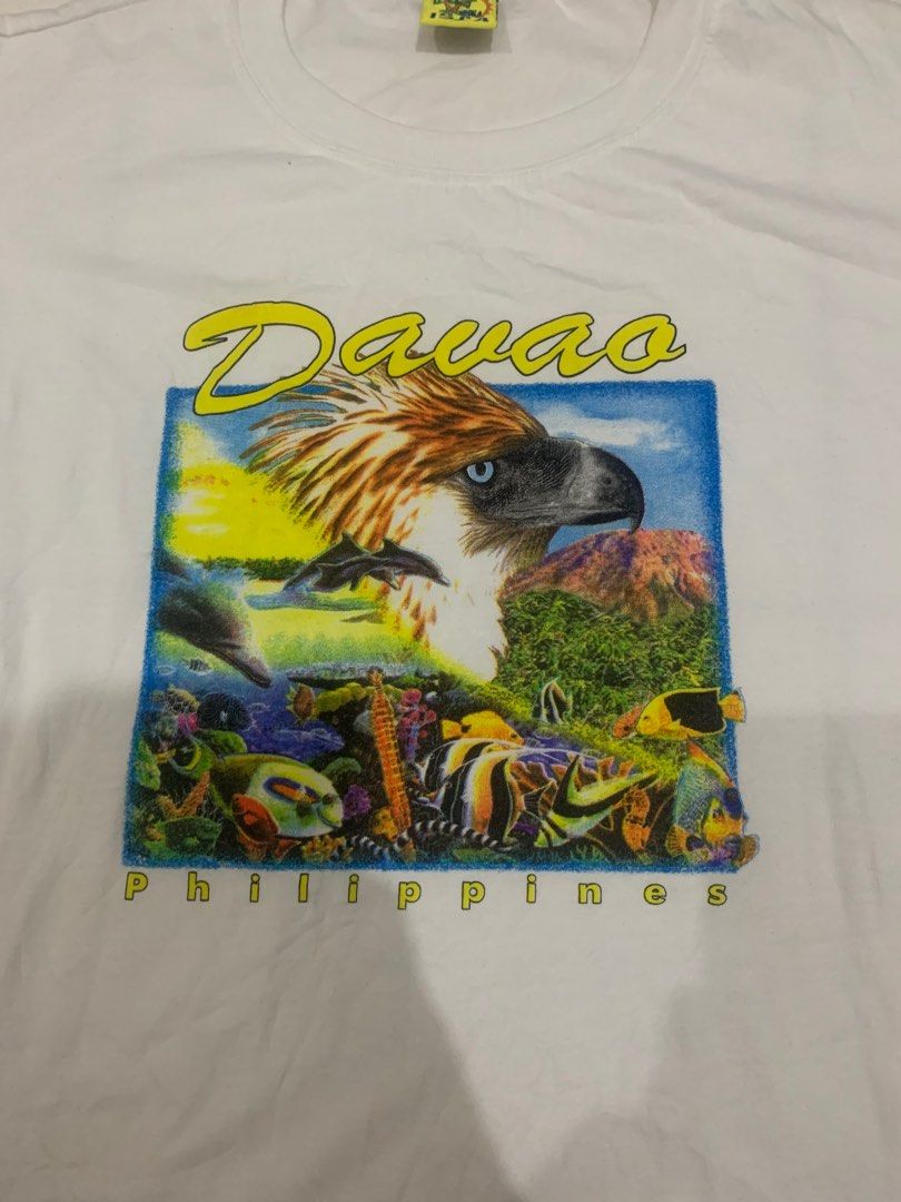 Davao Philippines Eagle Tee (Category: Tshirts & Polo Shirts ) located in Iloilo. Submitted by marctupas (Listing ID 1416554351, Image 2). Description: - Davao Philippines Eagle Tee - Size: 2XL - Color: White - Features a detailed eagle design with underwater elements - Made in the Philippines - Material: 65% Cotton, 35% Polyester - Condition: Good -22.5x27.5.