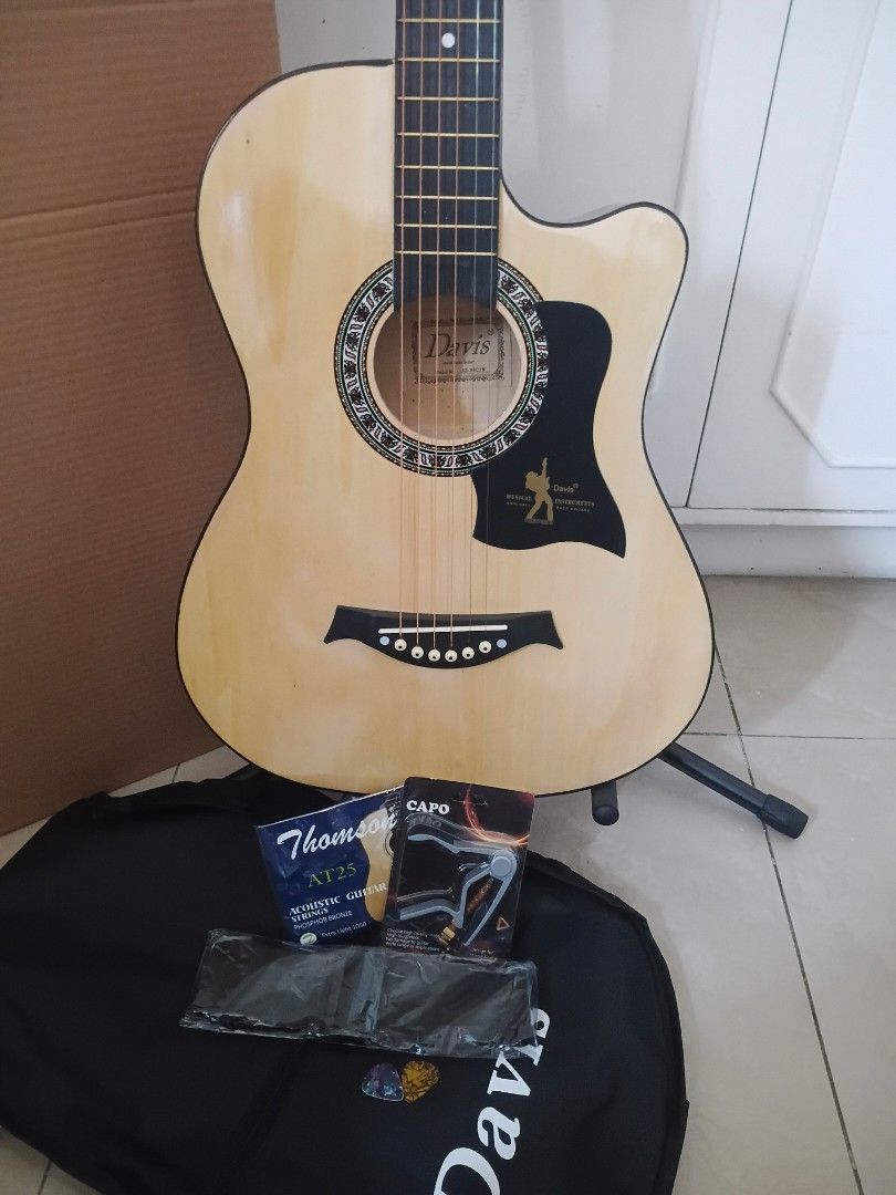 Davis Acoustic Guitar with Accessories (Category: Musical Instruments) located in Quezon City. Submitted by diwaguitars (Listing ID 1416477194, Image 1). Description: Brand New Acoustic Guitar for sale Davis JG38C 38 inches kaya pwedeng pwede sa mga bata, beginners, o kahit marunong ka na at gusto mo lang ng extra guitar na madaling bitbitin Inclusions: Guitar Bag Guitar Strap Set of Steel Strings Gauge 10 Capo Picks Brand new with box Selling fo