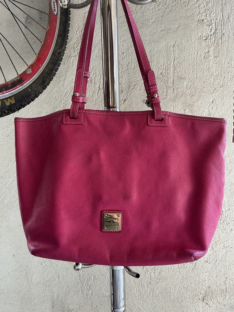 Dooney & Bourke Pink Tote Bag (Category: Tote Bags) located in Santa Maria. Submitted by marvi_declutter (Listing ID 1416563656, Image 1). Description: - Vibrant pink Dooney & Bourke tote bag - Classic top handle design - Spacious interior for all your essentials - Features a small, secure zippered pocket - Elegant leather construction - Subtle logo plaque detail.