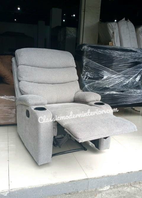 Gray Recliner Chair with Cup Holders (Category: Chairs) located in Manila. Submitted by classicmoderninterior.com (Listing ID 1416442443, Image 2). Description: - CM 8018 Fabric Gray recliner chair - Two cup holders - Padded armrests - Reclining feature - Textured fabric - Ideal for living rooms - Stylish and functional.