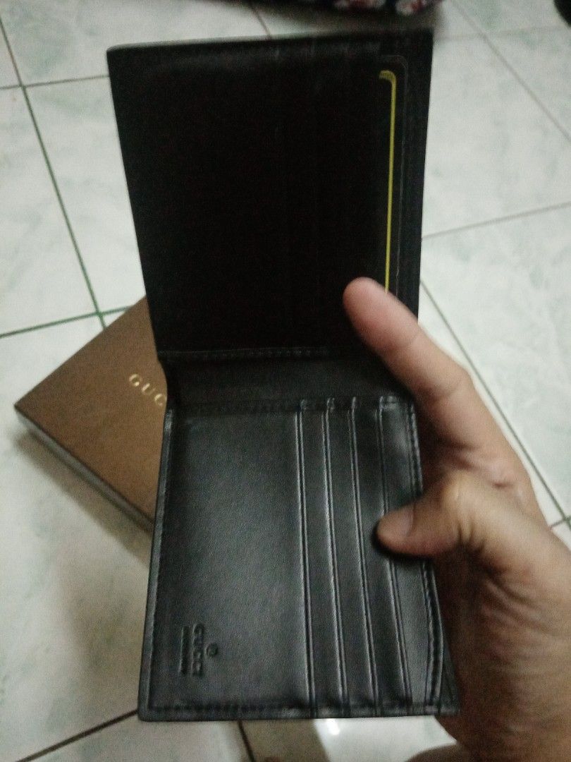 Gucci Black Leather Wallet (Category: Luxury Bags & Wallets) located in Marikina City. Submitted by rjhay251210 (Listing ID 1416564709, Image 3). Description: - Authentic Gucci wallet - Black leather exterior - Embossed Gucci logo - Multiple card slots - Bill compartment - Black leather interior with Gucci logo - Comes with original Gucci box.