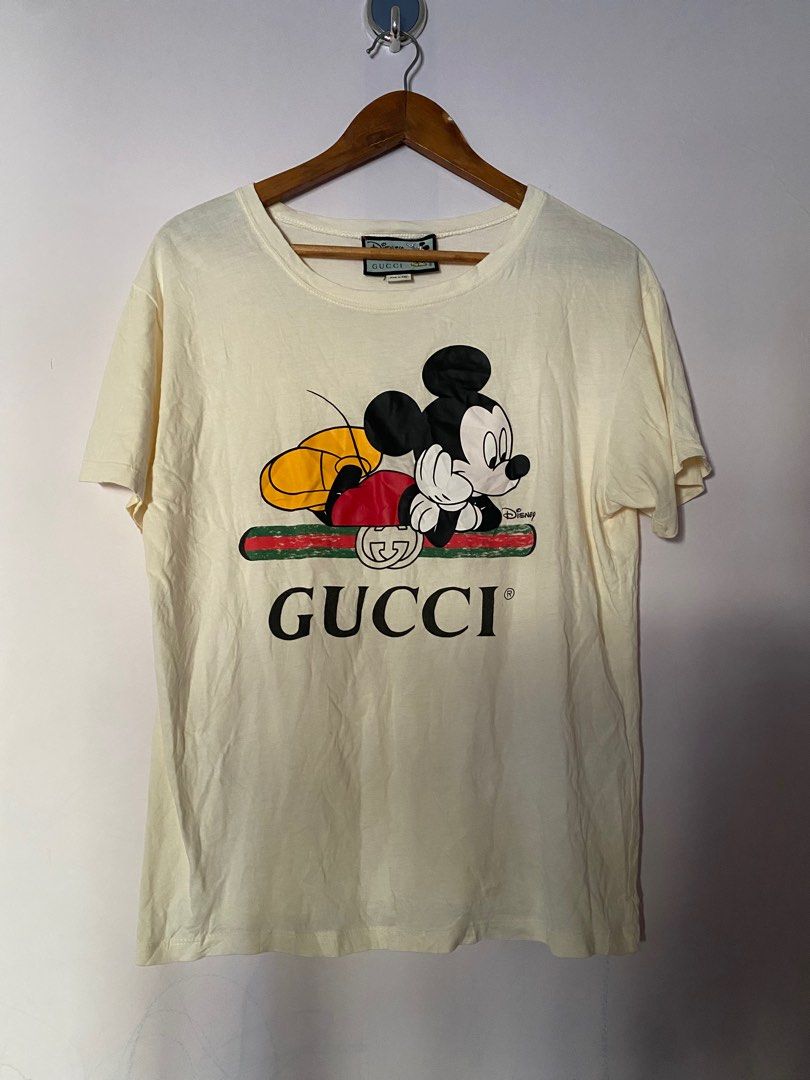 Gucci Disney Mickey Mouse T-shirt (Category: Luxury Apparel) located in Binmaley. Submitted by maryjeyn (Listing ID 1416453563, Image 1). Description: - Authentic Gucci T-shirt - Features a Disney Mickey Mouse design - Cream color - Size: Small - Made in Italy - Round neck and short sleeves - Gucci logo and Mickey Mouse graphic on the front 20x25.