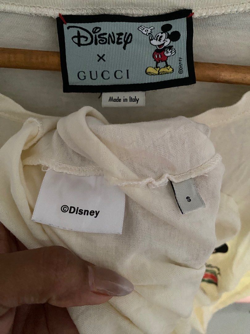 Gucci Disney Mickey Mouse T-shirt (Category: Luxury Apparel) located in Binmaley. Submitted by maryjeyn (Listing ID 1416453563, Image 2). Description: - Authentic Gucci T-shirt - Features a Disney Mickey Mouse design - Cream color - Size: Small - Made in Italy - Round neck and short sleeves - Gucci logo and Mickey Mouse graphic on the front 20x25.