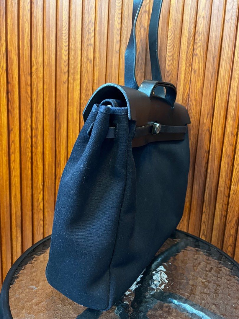 Hermès Herbag (Category: Luxury Bags & Wallets) located in Mandaluyong City. Submitted by AvekLuxuriesPh2020 (Listing ID 1416595057, Image 3). Description: Hermès Herbag MM in black canvas with leather trim. Classic, lightweight, and versatile—often called the casual Kelly. Preloved with normal signs of use. Clean interior, structure intact. Note: Missing metal button engraved with “HERMÈS PARIS” 1 side, please see photo for your reference.. ✔️Ac