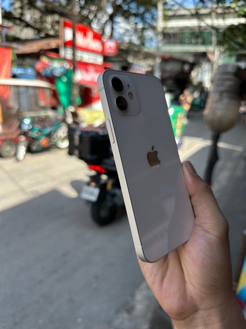 Iphone 12 (Category: iPhone 12 Series) located in Quezon City. Submitted by mubrogadgets (Listing ID 1416485604, Image 3). Description: FOR SALE: iPhone 12 🤍 (White) 💸 ₱12,800 na lang! Sulit deal! ✅ 64GB Storage – smooth pang-daily use ✅ No Issue / All Goods – tested, maayos gamitin ✅ NTC Approved – legit at safe gamitin sa PH 🔋 77% Battery Health – original battery, hindi palit ✨ Premium Design + Solid Performance 📸 Ganda ng camera – malinaw