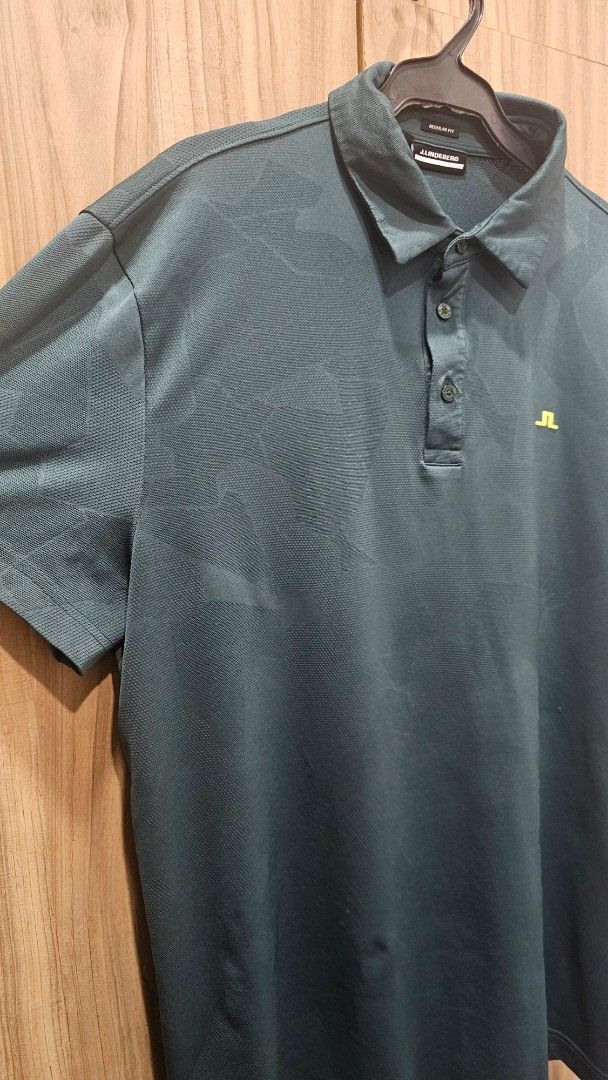 J. Lindeberg Golf Polo Shirt (Category: Tshirts & Polo Shirts ) located in Paranaque City. Submitted by misternpa (Listing ID 1416562552, Image 2). Description: - J.Lindeberg golf polo shirt - Dark green color - Classic polo collar - Three-button placket - J.Lindeberg logo on chest - Made from polyester and elastane blend - Regular fit - Used 2x only - RFS: I prefer an XL size in JL .