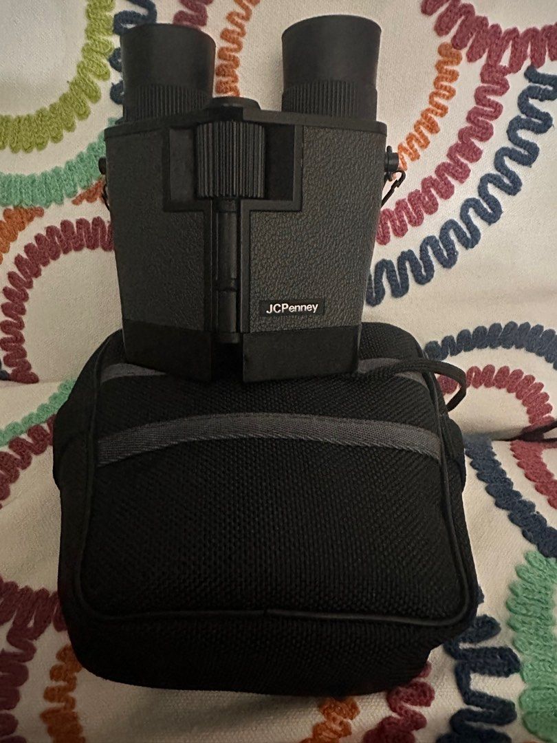 JCPenney Binoculars with Case (Category: Travel Essentials & Accessories) located in Manila. Submitted by youngdolphin-00c7ca (Listing ID 1416500769, Image 2). Description: - Compact JCPenney binoculars - Includes carrying case and neck strap - Textured black exterior - Clear lenses - Focus adjustment wheel - Case has black exterior with gray stripe - Binoculars marked 'PASSED' - RFS decluttering and extra funds.