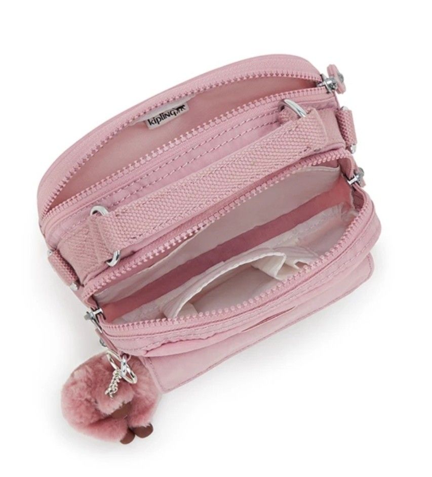 Authentic Kipling Puck Convertible Bag Flouncy Pink (Small type) (Category: Backpacks) located in Davao. Submitted by jilly07 (Listing ID 1416571030, Image 2). Description: Kipling Puck is a versatile bag that can be worn as a crossbody or carried by its top handle. It features multiple compartments for organization, including a front pocket and interior pockets. The bag comes with a detachable monkey keychain. It is a stylish and practical acces